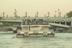 Image of people talking on a boat on the Seine River.